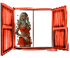 Woman stands in the window