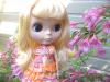 Cute blonde blythe doll with a bunch of flowers