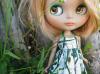 Cute blonde blythe doll in the nature