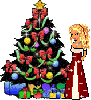 Blonde doll in a red dress standing next to a christmas tree